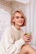 © zinkevych - Girlfriend smiling while drinking yummy juice in the bedroom