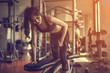 © Take Production - Fitness girl lifting dumbbell on gym.