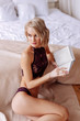 © zinkevych - Blonde woman with short hair cut reading book in the bedroom