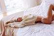 © zinkevych - Skinny young woman stretching in bed feeling truly relaxed