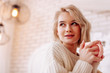 © zinkevych - Beautiful woman with natural makeup drinking tea at home