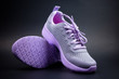 Pair of unbranded purple color sport or running shoes on a black background