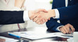 © rogerphoto - Business people shaking hands finishing up a meeting. Handshake at successful negotiation