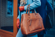 Beauty And Fashion. Stylish Fashionable Woman Wearing Coat And Gloves ,holding Brown Bag Handbag