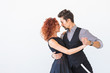 © satura_ - Social dance, kizomba, tango, salsa, people concept - beautiful couple dancing bachata on white background with copy space
