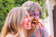 © satura_ - Festival of holi and technology concept - young couple making selfie at the festival
