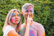 © satura_ - Holiday, holi and people concept - Happy couple having fun covered in paint