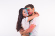 © satura_ - Holiday, holi and people concept - Smiling funny woman and man posing with multicolored powder on their faces on white background