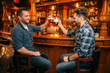 © Nomad_Soul - Two male friends drinks beer at the counter in pub