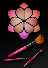 Professional make-up brush on a beautiful multicolored eyeshadow palette