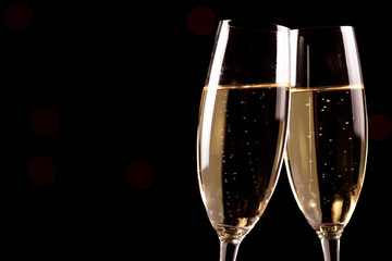 Wall Mural - Champagne glasses on black background. Holiday celebration concept.