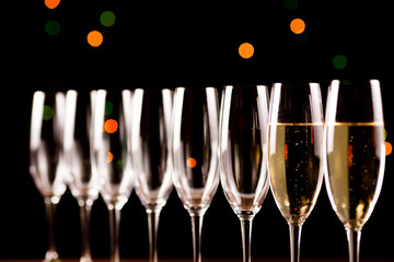 Wall Mural - Champagne glasses on black background. Holiday celebration concept.