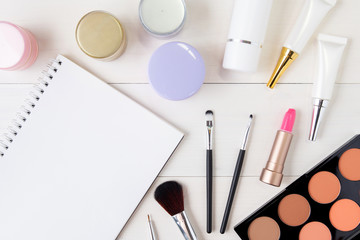 cosmetic and skin care product and notebook on white wood table, beauty with treatment cream and moi