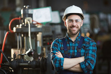 Waist Up Portrait Of Bearded Factory Worker Wearing Hardhat Looking At Camera While Standing In Workshop, Copy Space