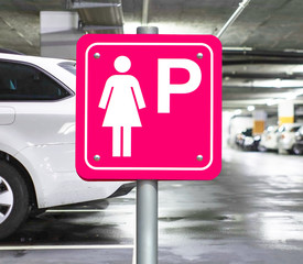 Wall Mural - Parking place only for women inside the public garage. Lady parking pink sign on the parking lot.