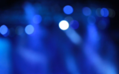 blurred concert light with colored spotlights and smoke.