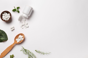 Composition with plant based pills on white background