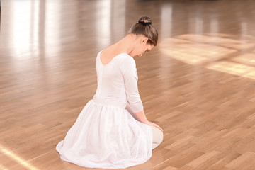 Beautiful young ballerina in dance studio