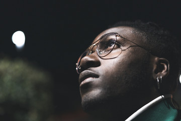 Handsome African-American guy with street glasses. Black man serious