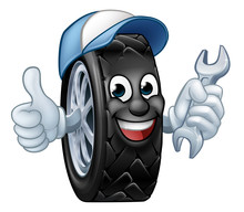 A Tyre Cartoon Car Mechanic Service Mascot Holding A Spanner And Giving A Thumbs Up