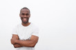 © mimagephotos - handsome young african american man smiling with arms crossed against isolated white background