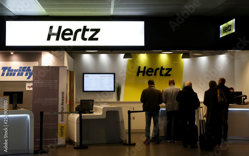 Logos Of Car Rental Company Hertz Are Seen At The Company S Desk