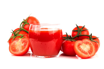 A glass of tomato juice with fresh ripe tomatoes on a white isolated background