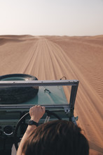 A Man Driving A Vintage 4x4 Car Offroad In The Desert On The Sand Dunes Of Dubai
