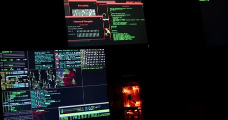 Maps and data on display screens in a dark office room