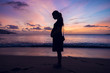 © dannyburn - A silhouette of a pregnant girl on a beautiful tropical beach at sunset dusk, relaxation and positive mental health during pregnancy for women. Healthy mind.