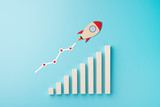 Fototapeta Tęcza - Rocket and chart on blue background business financial start up growth success concept object design