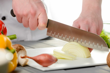 Wall Mural - Chef slicing a bulb onion