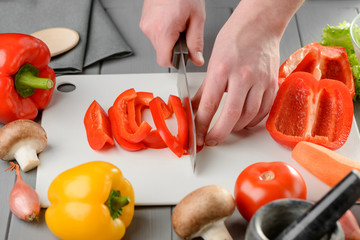 Wall Mural - Man cutting a bell pepper