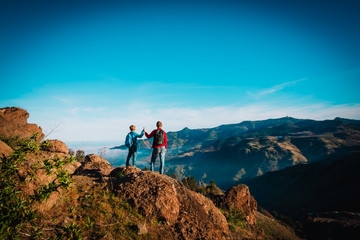 father and son travel in nature, family hiking in mountains