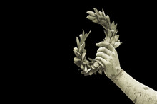 Hand Holds A Laurel Wreath - Bronze Statue On Black Background - Success And Fame Concept Image - Image With Copy Space