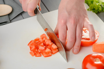 Wall Mural - Man chopping a tomato