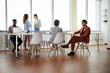 © Seventyfour - Multi-ethnic group of contemporary business people working in office, copy space