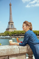 tourist woman with cup of coffee and croissant exploring attract