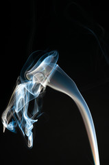 Isolated white and blue smoke on black background. Design element. Natural smoke.