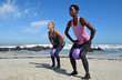 © Westend61 - Two women doing fitness exercises with ball on the beach