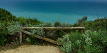 Wooden Fence Near Ocean With Two Green Colors