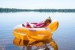 © mihakonceptcorn - The little girl is resting in an inflatable chair, floating on the water.