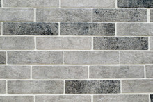 Mottled Grey Brick Tiles With White Grouting.