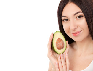 Poster - Cute woman with beautiful smile holding avocado. Healthy lifestyle and nutrition, dieting, weight loss, cosmetology, dental care and healthy teeth consept Close up portrait of beautiful woman isolated