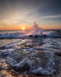Waves crashing on the rocks at sunrise in Ocean City, MD. Photo by: Chuck Beyer