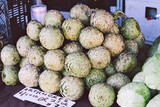 Fototapeta Kuchnia - Fresh green artichokes for sale at a farmers market stall