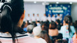 © Apichet - The parent listening and watching student on stage in convention hall.