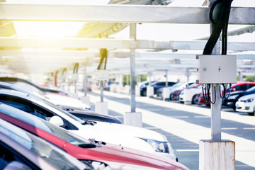 Wall Mural - Many solar photovoltaic panels are installed on the top of the open-air parking lot.