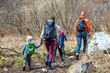 © Joe-L - Hiking children with backpacks. group of tourists walking along a forest path