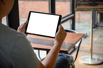 Poster - businessman hand working on tablet on wooden desk tablet with blank screen mockup Digital tablet computer